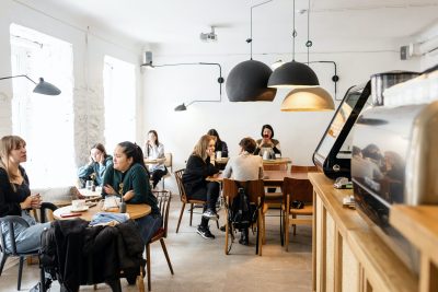 group-of-diverse-friends-sitting-in-modern-cafe-3952080